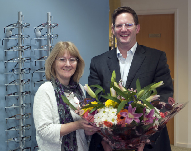 Mrs Roberts recieving a gift from optometrist Alisdair Buchanan to mark 10,000 patients at opticians Buchanan Optometrists, Kent